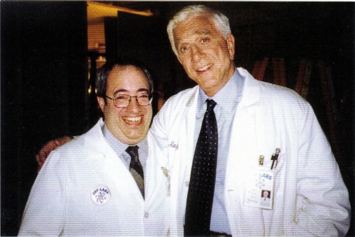 Jeff Eigen and Leslie Nielsen on the set of a Medicare commercial.  Leslie Nielsen started his career as a serious dramatic actor, but when he appeared in the movie, Airplane, his comic career took off.  He played a prank on me in this picture above while he was squeezing his whoopee cushion.  I will never forget the fun experience of working with Leslie Nielsen.  He was truly a great actor.
